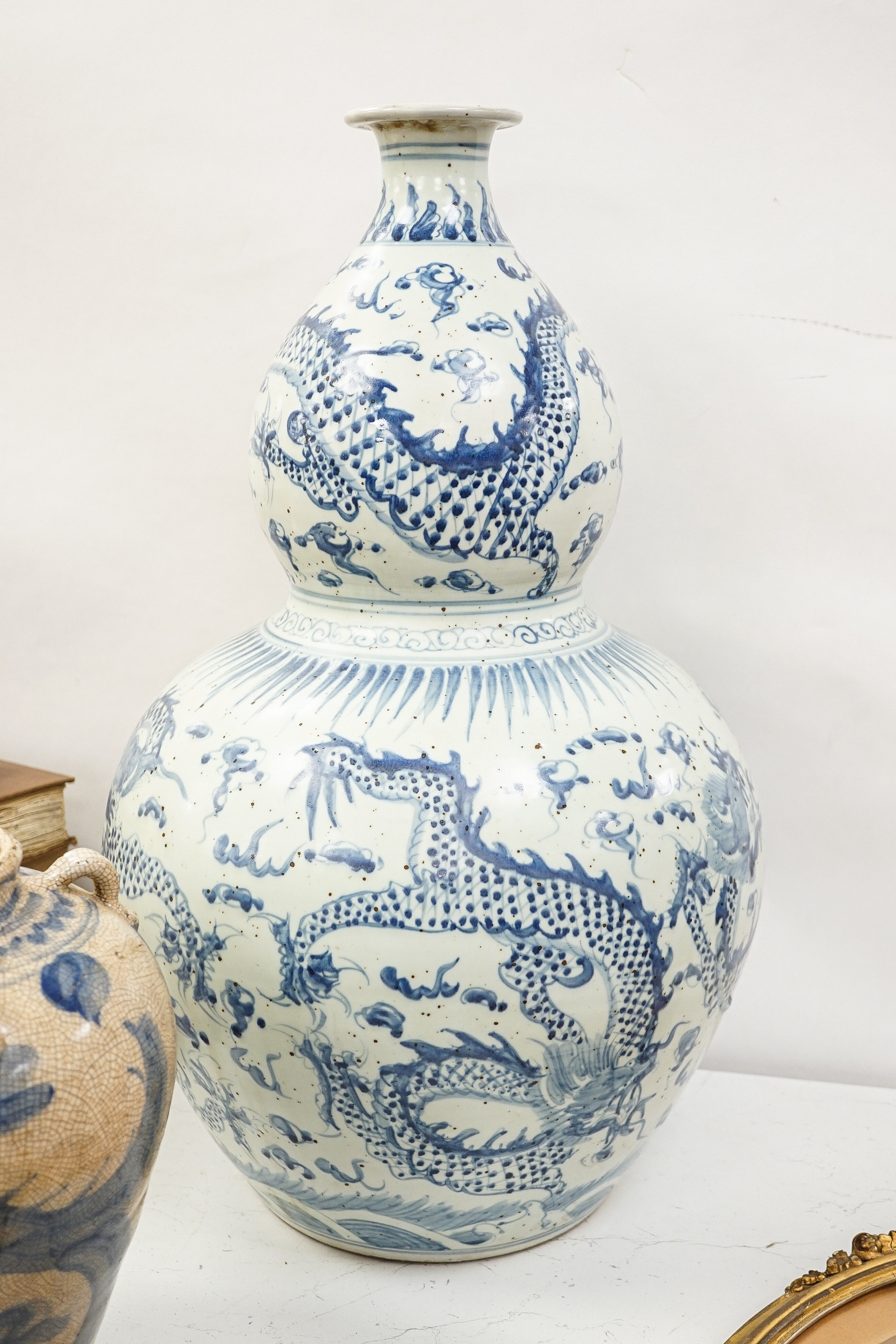 A large Chinese blue and white 'dragon' double gourd vase, 64cm high and an Annamesse style blue and white crackle glaze jar